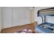 Bedroom featuring laminate floors, a closet, and a bunk bed at 9001 Tudor Dr # H210, Tampa, FL 33615
