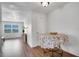 Inviting entryway with hardwood floors and decorated table with floral tablecloth at 9001 Tudor Dr # H210, Tampa, FL 33615