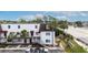 White two-story building with brown accents and palm trees in front of the parking lot at 9001 Tudor Dr # H210, Tampa, FL 33615