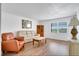 Comfortable living room with hardwood floors, cozy seating, and natural light from a nearby window at 9001 Tudor Dr # H210, Tampa, FL 33615