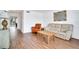 Bright living room featuring hardwood floors, comfortable seating, and views of outdoor greenery at 9001 Tudor Dr # H210, Tampa, FL 33615