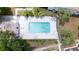 Overhead shot of the community pool with lounge chairs, tables, and shady trees at 9001 Tudor Dr # H210, Tampa, FL 33615