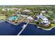 Expansive aerial view of waterfront community featuring pools, docks, and clubhouse on a lake at 933 Signet Dr, Apollo Beach, FL 33572