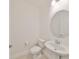 Well-lit half bathroom with toilet, pedestal sink, oval mirror, and modern fixtures at 933 Signet Dr, Apollo Beach, FL 33572
