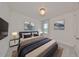 Comfortable bedroom with elegant lighting fixture, plush rug, and scenic artwork at 933 Signet Dr, Apollo Beach, FL 33572