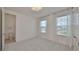 Bright bedroom with sheer curtains, neutral carpet, closet, and ensuite bathroom at 933 Signet Dr, Apollo Beach, FL 33572