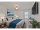 Inviting bedroom with blue accents, stylish furniture, and scenic artwork at 933 Signet Dr, Apollo Beach, FL 33572