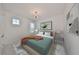 Well-furnished main bedroom with a full bed, side tables, abstract wall art, and a window at 933 Signet Dr, Apollo Beach, FL 33572