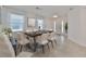 Bright dining room with modern table setting, ample natural light, and elegant decor at 933 Signet Dr, Apollo Beach, FL 33572