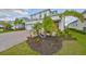 Charming two-story home with well-maintained landscaping and a vibrant, welcoming entrance at 933 Signet Dr, Apollo Beach, FL 33572