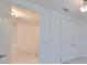 Hallway with white interior doors, with an opening to an upstairs landing at 933 Signet Dr, Apollo Beach, FL 33572