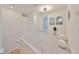 Second-floor hallway with modern light fixture, neutral carpet, and white staircase at 933 Signet Dr, Apollo Beach, FL 33572