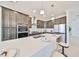 Modern kitchen featuring granite countertops, stainless steel appliances, and stylish bar stools at 933 Signet Dr, Apollo Beach, FL 33572