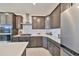 Contemporary kitchen featuring stainless steel appliances, gray cabinets, and a subway tile backsplash at 933 Signet Dr, Apollo Beach, FL 33572