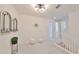 Bright loft area with neutral carpet, modern light fixture, and stylish decor at 933 Signet Dr, Apollo Beach, FL 33572