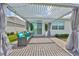 Covered patio featuring cozy seating, stylish curtains, and a serene outdoor ambiance at 933 Signet Dr, Apollo Beach, FL 33572
