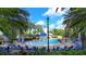 Fun community pool with water features, lounge chairs, and a lighthouse in a tropical setting at 933 Signet Dr, Apollo Beach, FL 33572