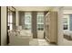 Bright bedroom with sitting area, large windows, and neutral color palette at 9344 Cannon Beach Dr, Parrish, FL 34219