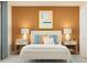 Cozy bedroom with a neatly made bed, colorful throw pillows, and side tables with lamps, creating a warm and inviting retreat at 9344 Cannon Beach Dr, Parrish, FL 34219