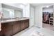 Bathroom features a double vanity, granite countertop, and walk-in closet at 9433 Channing Hill Dr, Sun City Center, FL 33573