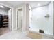 Bathroom with a frameless glass shower, tiled walls, and walk-in closet at 9433 Channing Hill Dr, Sun City Center, FL 33573