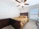 Well-lit bedroom with a ceiling fan, bed, and a dresser at 9433 Channing Hill Dr, Sun City Center, FL 33573