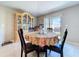 Dining area with table and china cabinet, filled with natural light at 9433 Channing Hill Dr, Sun City Center, FL 33573