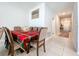 Charming dining room featuring a decorative table setting and adjacent hallway at 9433 Channing Hill Dr, Sun City Center, FL 33573