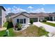 Attractive single-story home featuring a well-kept lawn, landscaping, and a two-car garage at 9433 Channing Hill Dr, Sun City Center, FL 33573