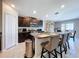 Modern kitchen with stainless steel appliances, granite countertops, and a center island with seating at 9433 Channing Hill Dr, Sun City Center, FL 33573
