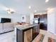 Spacious kitchen features stainless steel appliances, granite counters, and open layout to the living area at 9433 Channing Hill Dr, Sun City Center, FL 33573