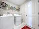 Functional laundry room with a washer, dryer, and shelving for storage at 9433 Channing Hill Dr, Sun City Center, FL 33573