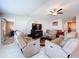 Comfortable living room with reclining sofas, a fireplace, and an open layout at 9433 Channing Hill Dr, Sun City Center, FL 33573