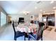 Open living area with dining table, kitchen island, and comfortable seating at 9433 Channing Hill Dr, Sun City Center, FL 33573