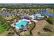 Resort-style community pool, clubhouse, with ample lounging area and lush tropical landscaping at 9433 Channing Hill Dr, Sun City Center, FL 33573