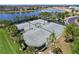 Aerial view of community tennis courts featuring lush landscaping and well-maintained playing surface at 9433 Channing Hill Dr, Sun City Center, FL 33573