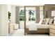 Calm bedroom features a four poster bed, dresser and a chair by the large window at 9816 Minnow Ray Dr, Land O Lakes, FL 34638