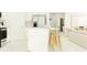 Open-concept kitchen with stainless steel appliances, a large island, and barstool seating, perfect for casual dining at 9816 Minnow Ray Dr, Land O Lakes, FL 34638