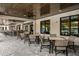 Outdoor seating area with a bar, tables, chairs, and a view of the pool at 9816 Minnow Ray Dr, Land O Lakes, FL 34638