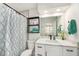 Well-lit bathroom with marble countertops, modern fixtures, and a stylish shower curtain at 1000 W Horatio St # 207, Tampa, FL 33606