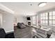 Open-concept living room with fireplace and dining area, featuring hardwood floors and modern lighting at 1000 W Horatio St # 207, Tampa, FL 33606