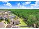 Aerial view showcasing a house on a lot with large back yard and views of surrounding community at 10703 Morning Dew Way, Tampa, FL 33647