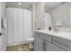 The bathroom is complete with a shower and a vanity with a countertop at 10703 Morning Dew Way, Tampa, FL 33647