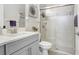 The bathroom boasts a glass door shower and elegant light fixtures at 10703 Morning Dew Way, Tampa, FL 33647