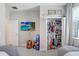 This bedroom features a closet with contents, TV, and beanbag seating at 10703 Morning Dew Way, Tampa, FL 33647