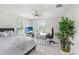 This bedroom features a ceiling fan, a bed, a desk, and plenty of light at 10703 Morning Dew Way, Tampa, FL 33647