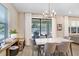 Bright dining area with a modern chandelier and sliding doors leading to the backyard at 10703 Morning Dew Way, Tampa, FL 33647