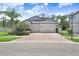 Charming two-story home featuring a spacious three-car garage and well-manicured landscaping at 10703 Morning Dew Way, Tampa, FL 33647