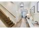 Inviting hallway with wood floors, elegant lighting, and a staircase leading to the second floor at 10703 Morning Dew Way, Tampa, FL 33647