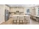 Modern kitchen featuring an island with seating, stainless steel appliances, and ample cabinet space at 10703 Morning Dew Way, Tampa, FL 33647